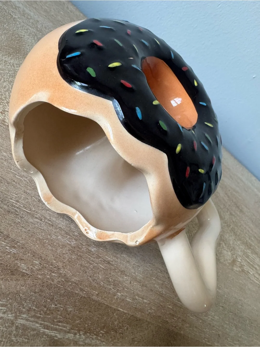 Donut-Shaped Ceramic Mug with Black Frosting and Tan Body
